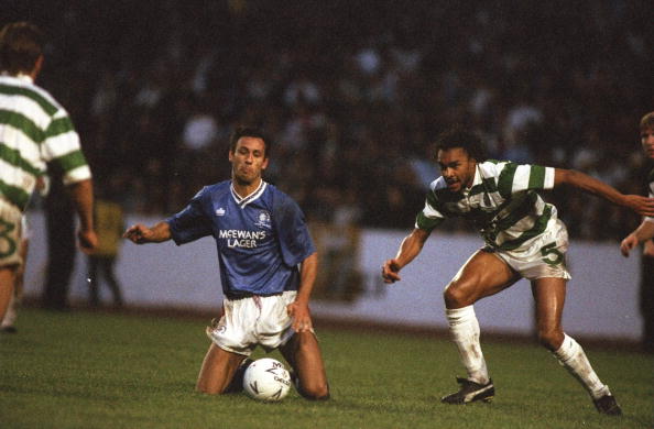 Oct 1990:   Mark Hately (centre) of Rangers goes down on his knees as Paul Elliott #5 of Celtic moves in during the Skol Cup Final at Hampden Park ...