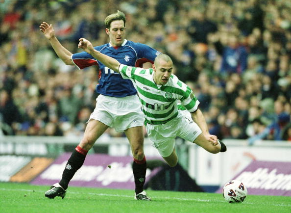 10 Mar 2002:  Henrik Larsson of Celtic flies through the air after a tackle from Fernando Ricksen of Rangers during the Scottish Premier League mat...