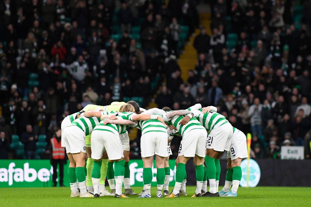 The Celtic team huddle before kick-off