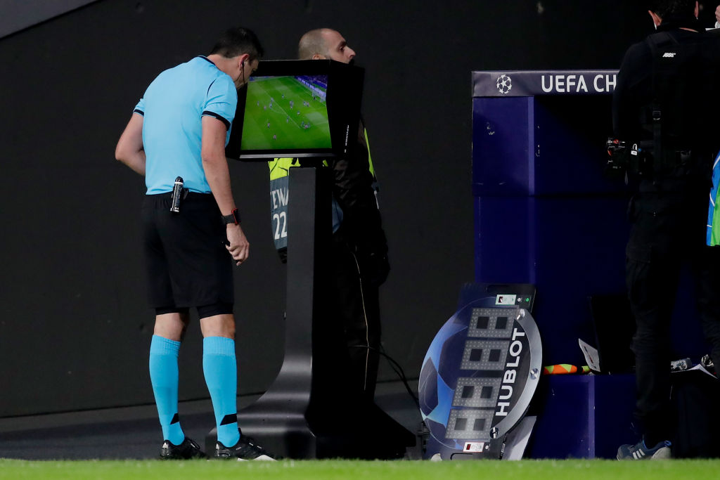 A UEFA referee checks VAR monitor