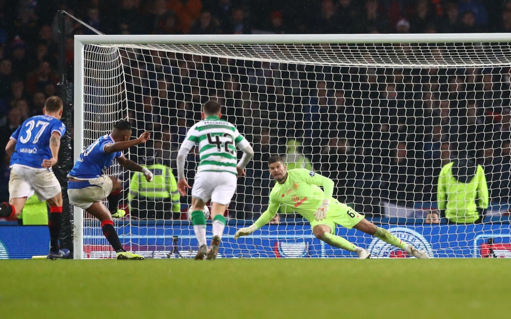 Celtic goalkeeper Fraser Forster saving a Rangers penalty