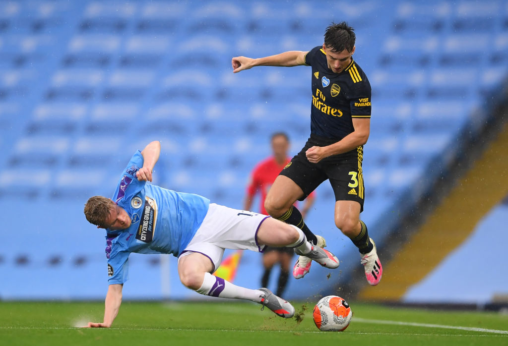 Kieran Tierney competes with Kevin De Bruyne