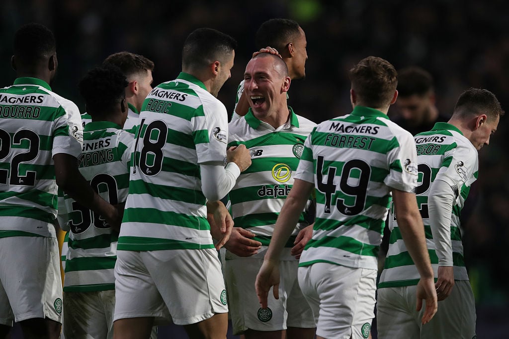 Celtic players celebrate a goal against Livingston last season