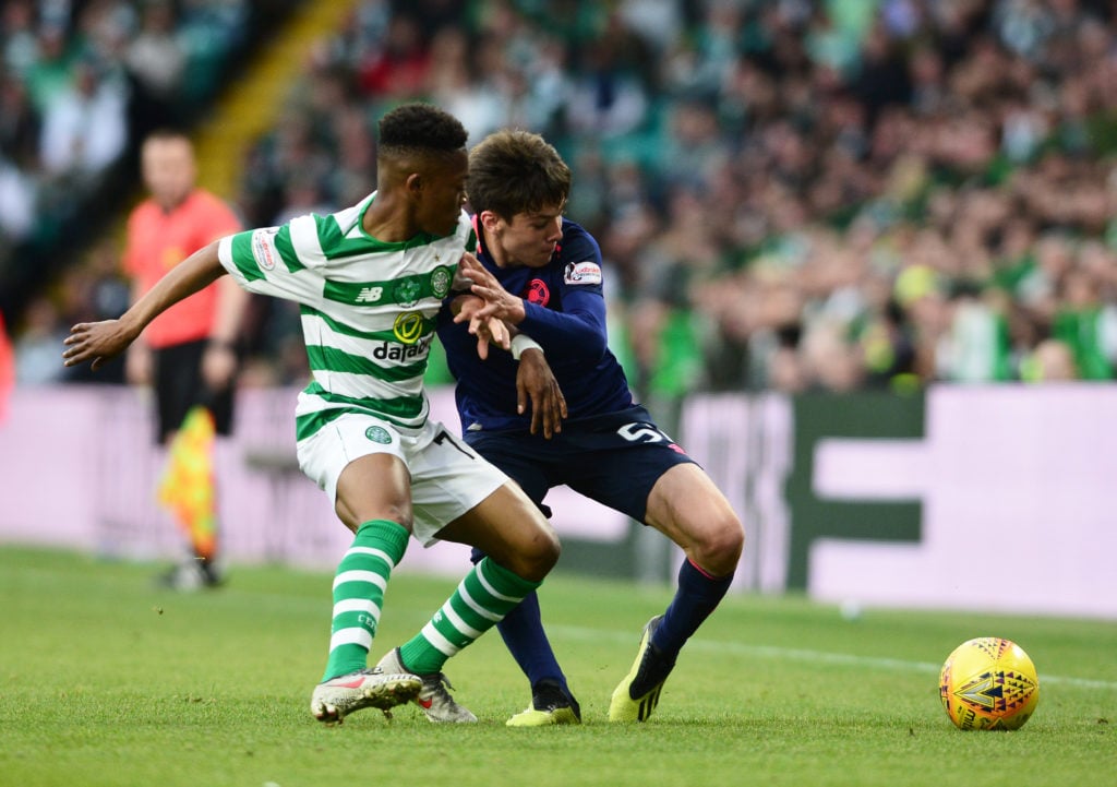 Aaron Hickey of Hearts holds off Karamoko Dembele of Celtic during the Ladbrokes Scottish Premiership match between Celtic and Hearts at Celtic Par...