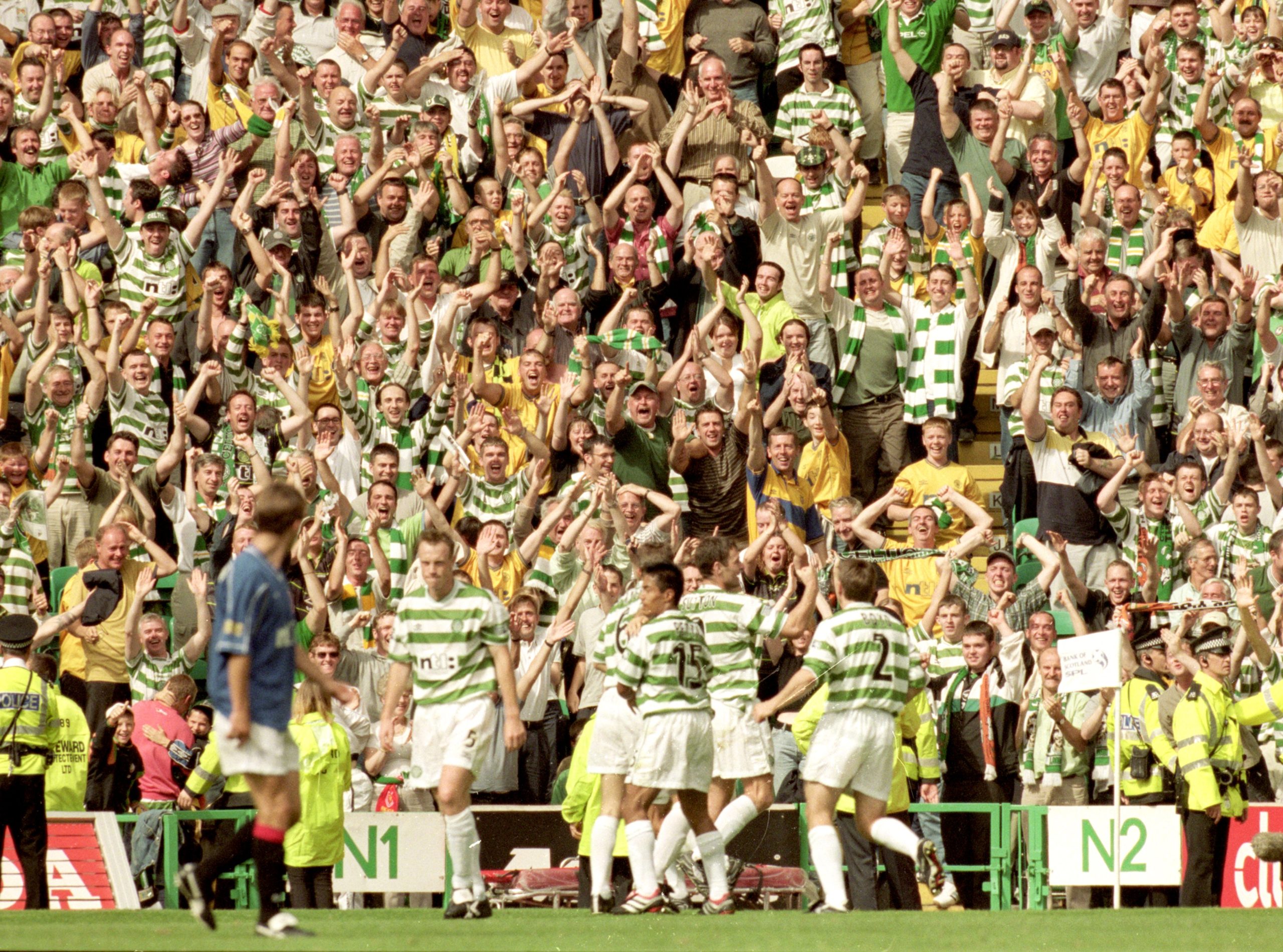 Celtic players and fans celebrate a goal in the legendary 6-2 win over Rangers in 2000