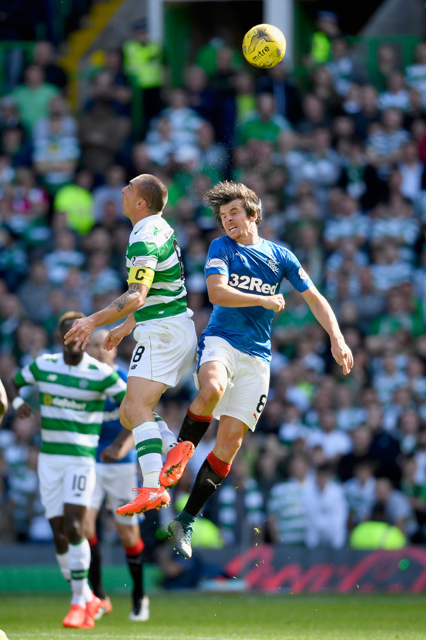 Scott Brown and Joey Barton challenge for the ball