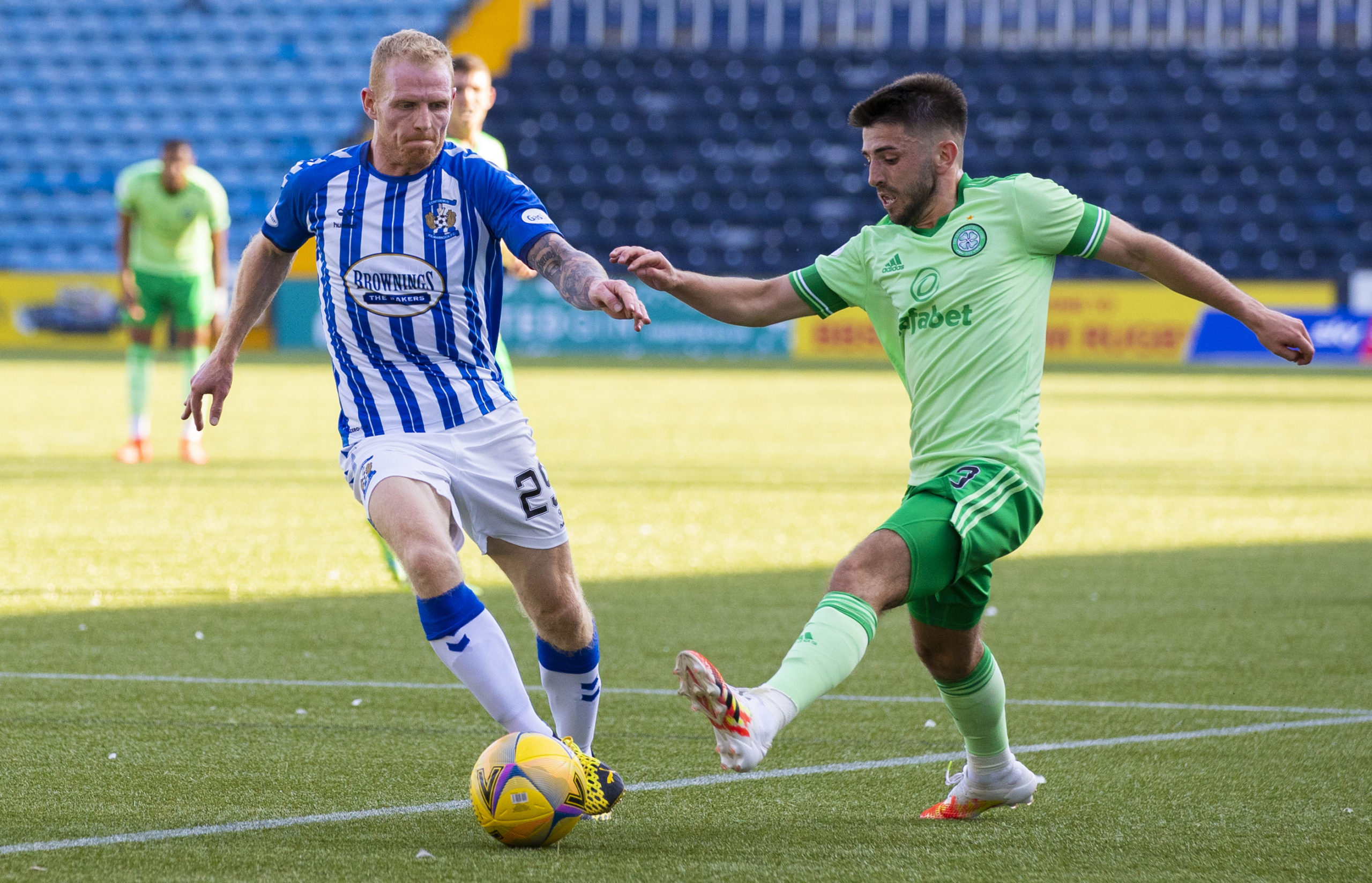 KILMARNOCK, SCOTLAND - AUGUST 09: Celtic's Greg Taylor holds off Kilmarnock's Chris Burke during a Scottish Premiership match between Kilmarnock an...