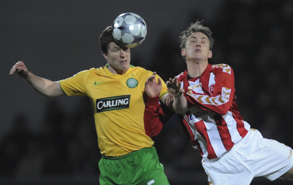 Celtic's Gary Caldwell (L) fights for th