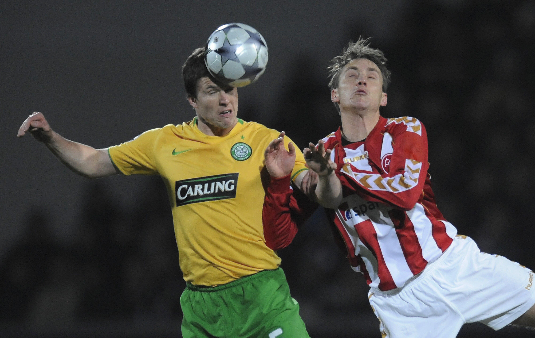 Celtic's Gary Caldwell (L) fights for th