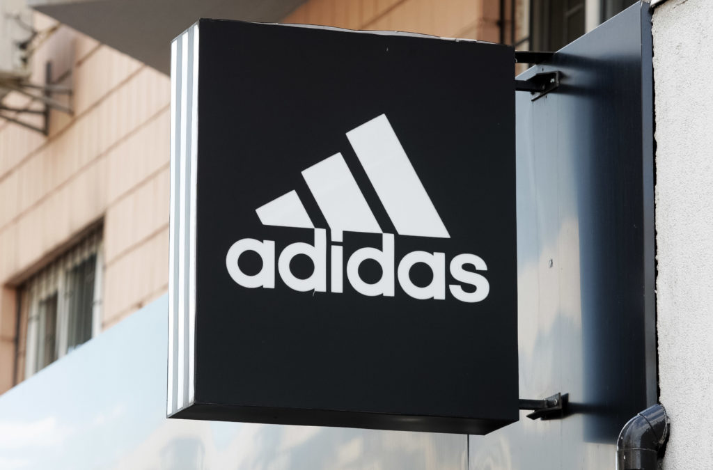 The Adidas logo on the outside of a shop