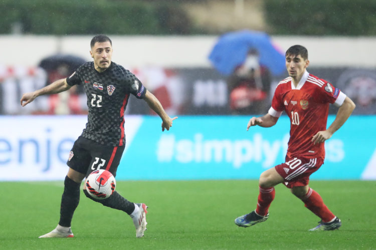 SPLIT, CROATIA - NOVEMBER 14: Josip Juranovic of Croatia and  Zelimkhan Bakaev of Russia in action during  the 2022 FIFA World Cup Qualifier match ...