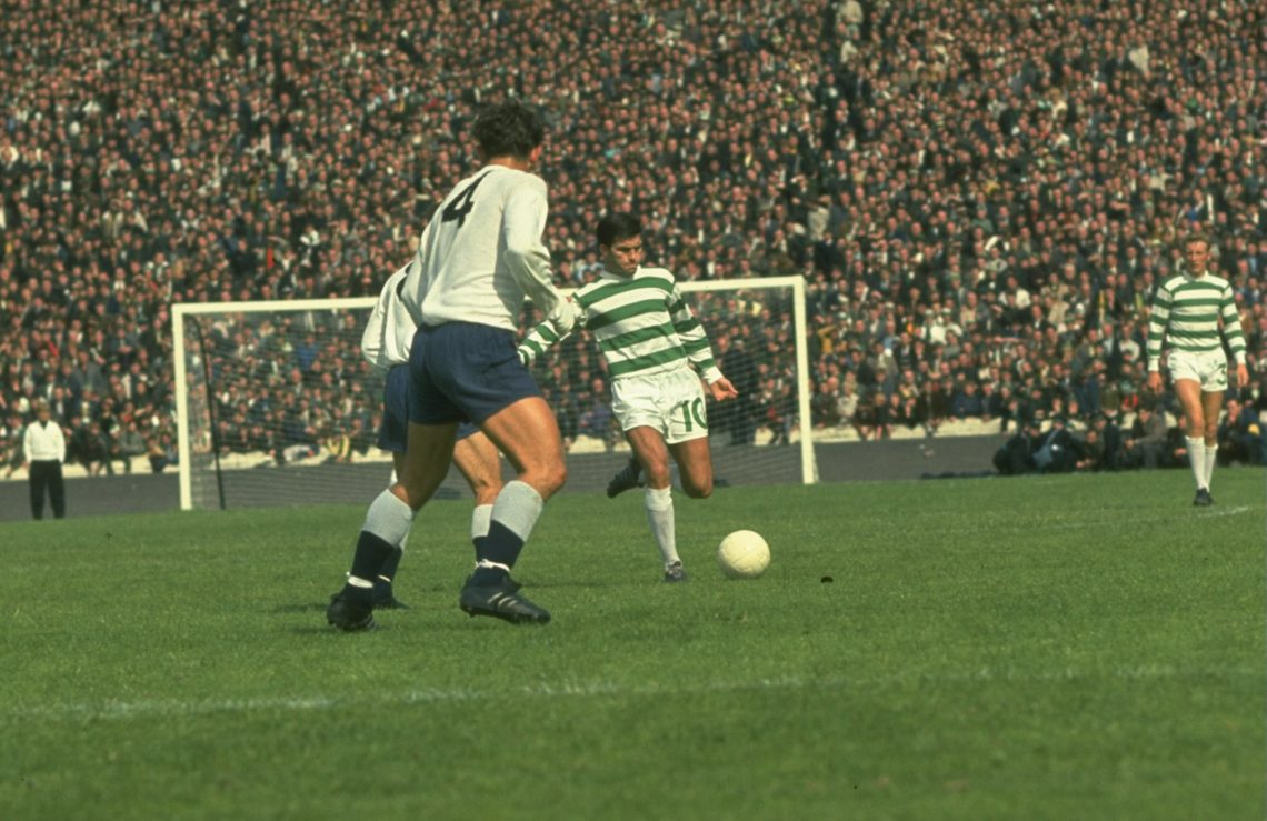 Undated: Bertie Auld of Celtic (centre) kicks the ball away as Alan Mullery #4 of Tottenham Hotspur watches during a Friendly match at Celtic Park...