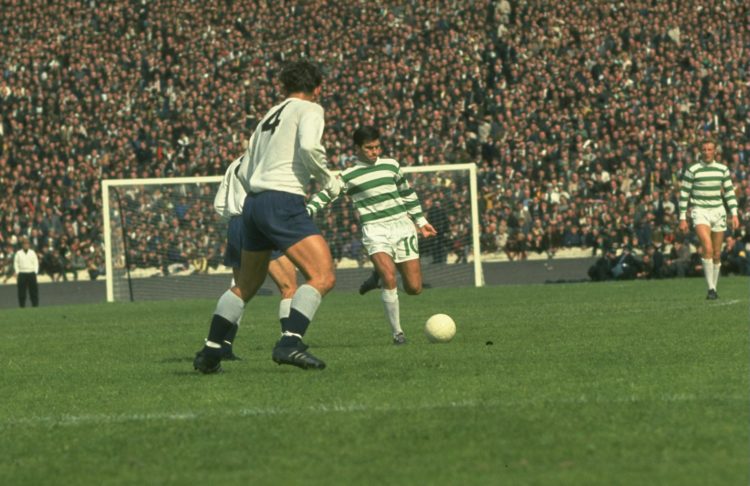 Undated:  Bertie Auld of Celtic (centre) kicks the ball away as Alan Mullery #4 of Tottenham Hotspur watches during a Friendly match at Celtic Park...