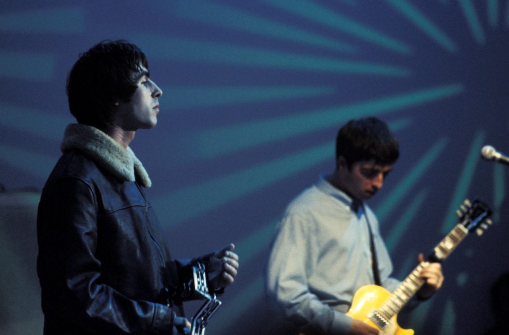 Liam Gallagher and Noel Gallagher of Oasis performing on UK TV show The White Room in 1995