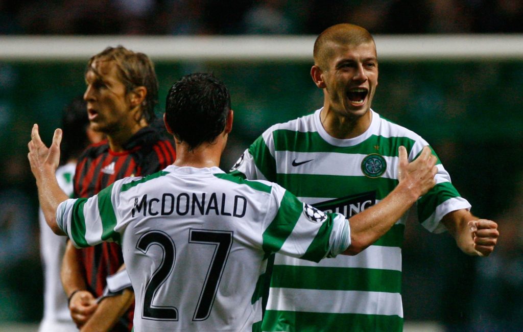Massimo Donati of Celtic celebrates with Scott McDonald after Celtic beat AC Milan in the Champions League