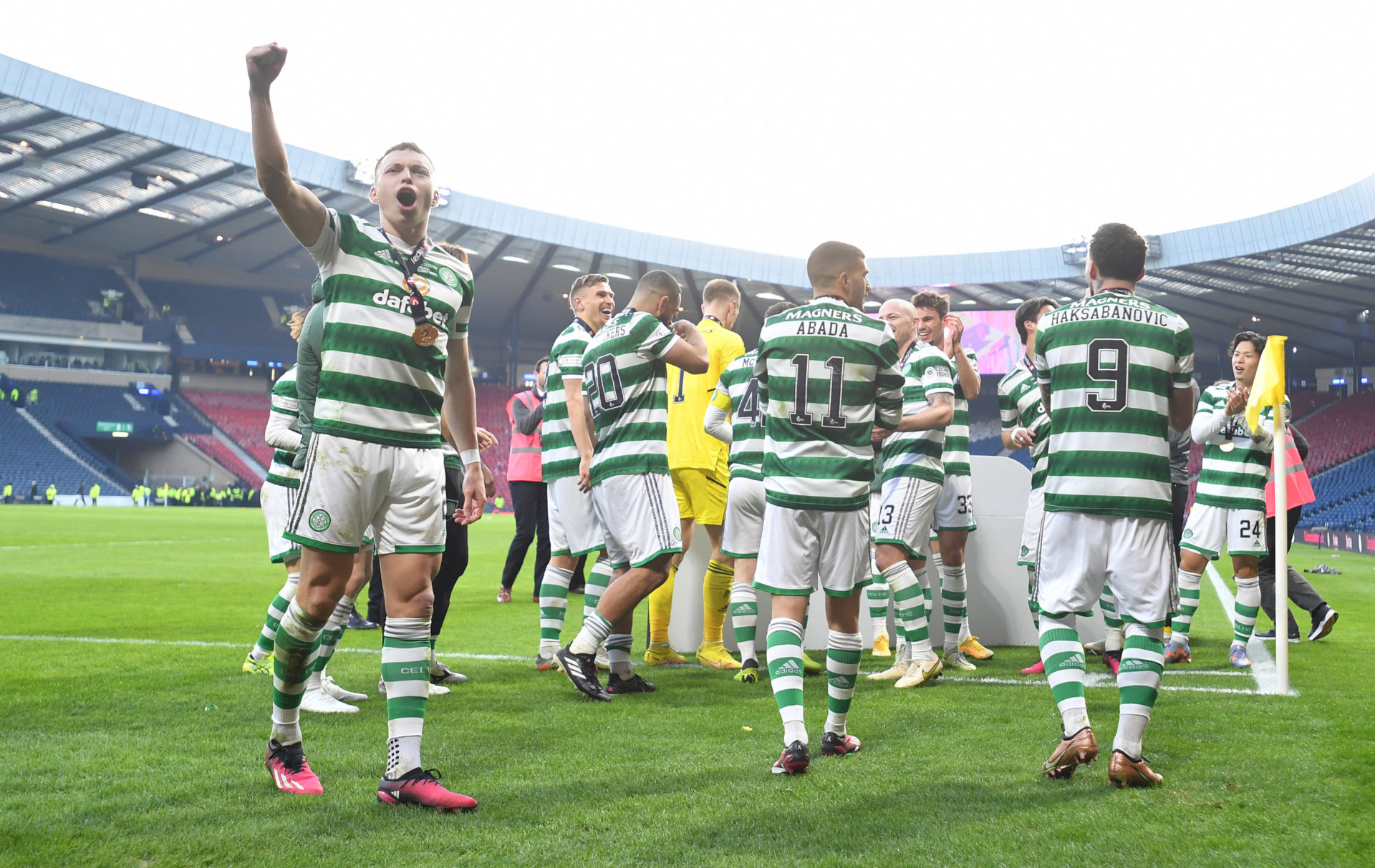 Celtic players celebrate on the Hampden surface