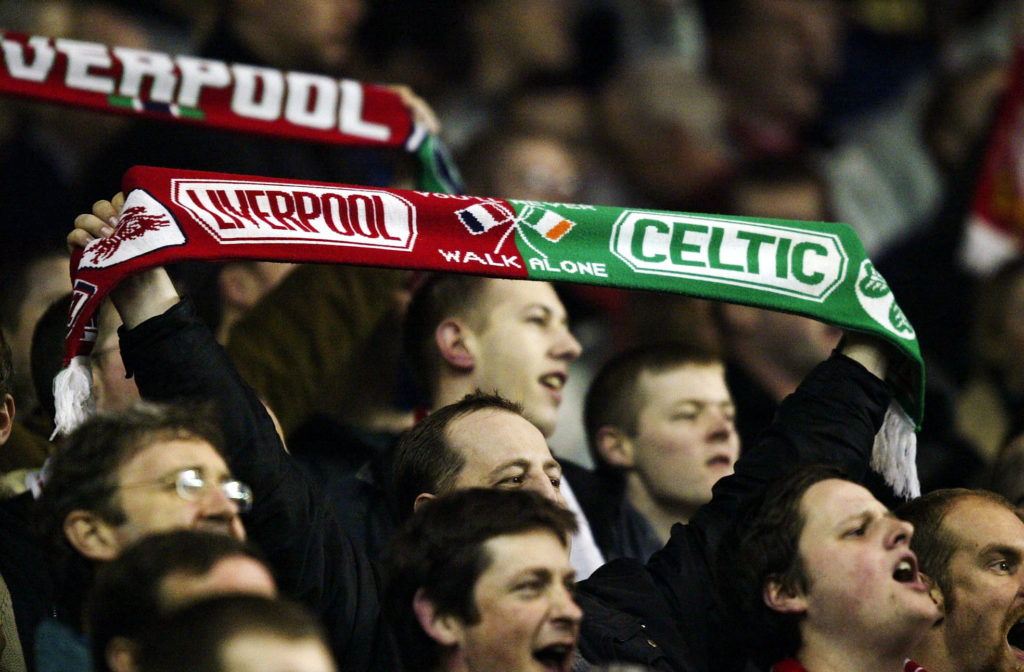 A Liverpool fan shows off his Celtic/Liverpool scarf