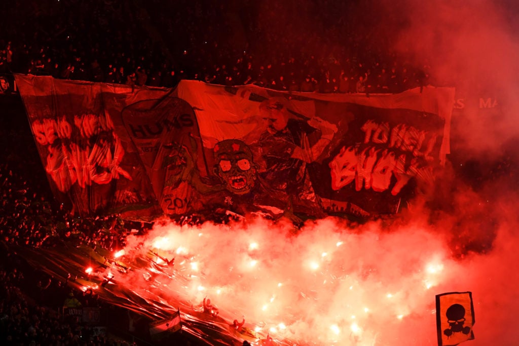 Celtic fans light flares and unfurl a banner as they show their support before the start of the Cinch Scottish Premiership match between Celtic FC ...