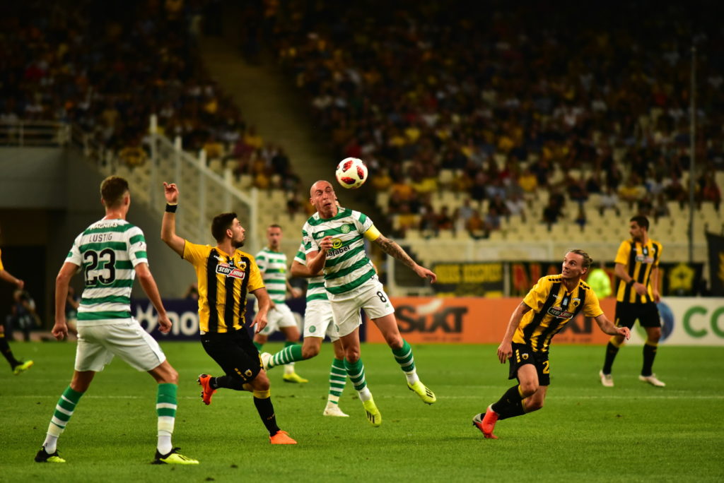 Brown Scott (no 8) of Celtic (centre), stops an attack of
