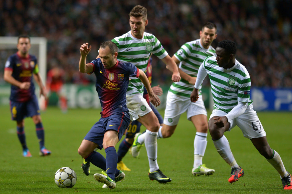 Charlie Mulgrew and Victor Wanyama of Celtic challenge Andres Iniesta of Barcelona during the UEFA Champions League Group G match between Celtic an...
