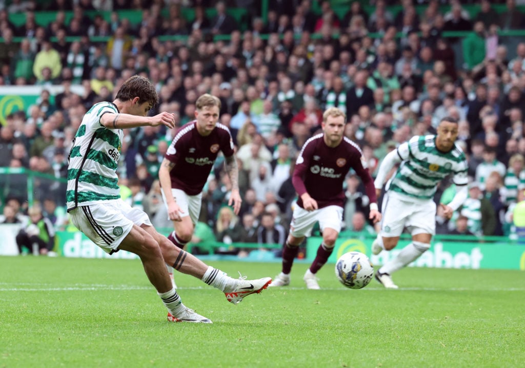 Matt O'Riley of Celtic scores his team's third goal from the penalty spot during the Cinch Scottish Premiership match between Celtic FC and Heart o...