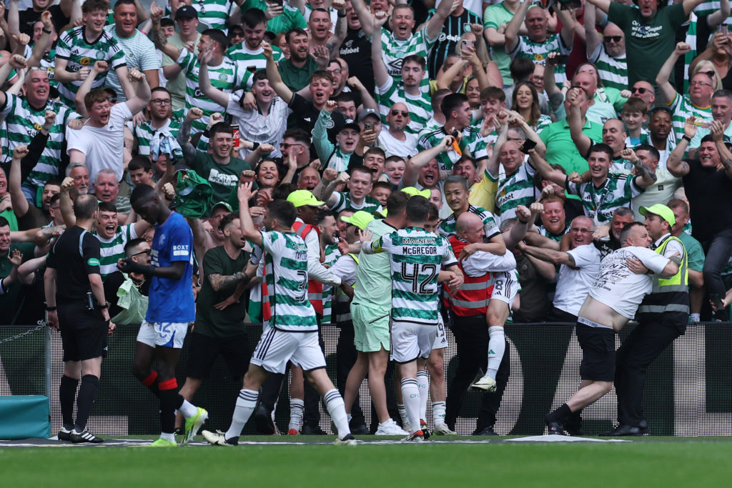 Celtic fans and players celebrate after John Lundstram of Rangers (not pictured) scores an own goal, Celtic's second goal during the Cinch Scottish...