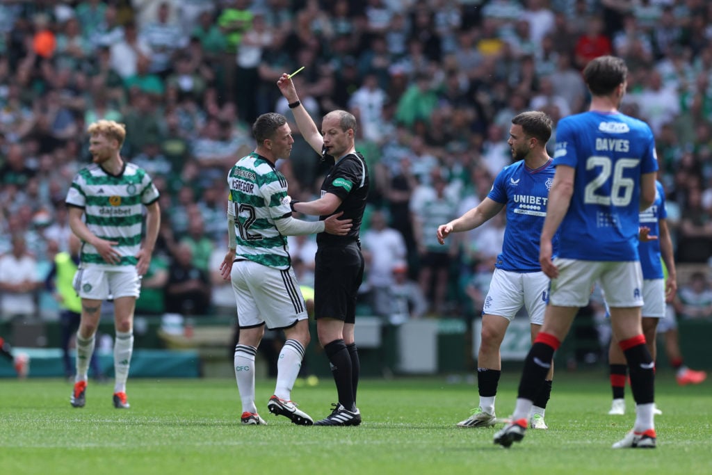 Referee, William Collum shows a yellow card to Callum McGregor of Celtic during the Cinch Scottish Premiership match between Celtic FC and Rangers ...