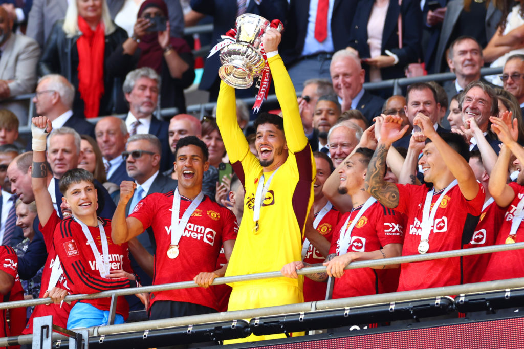 Manchester United's Altay Bayindir lifts the trophy following the Emirates FA Cup Final match between Manchester City and Manchester United at Wem...