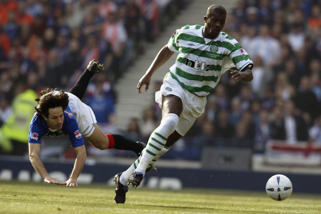 Dianbobo Balde of Celtic skips past Jerome Bonnissel of Rangers