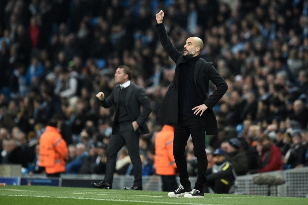 Manchester City's Spanish manager Pep Guardiola (R) and Celtic's Northern Irish manager Brendan Rodgers watch the players during the UEFA Champions...