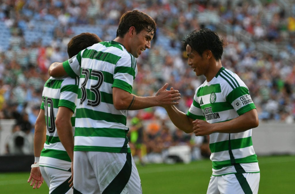 Celtic's German forward #10 Nicolas-Gerrit Kühn celebrates scoring his team's first goal with Celtic's English midfielder #33 Matt O'Riley during t...