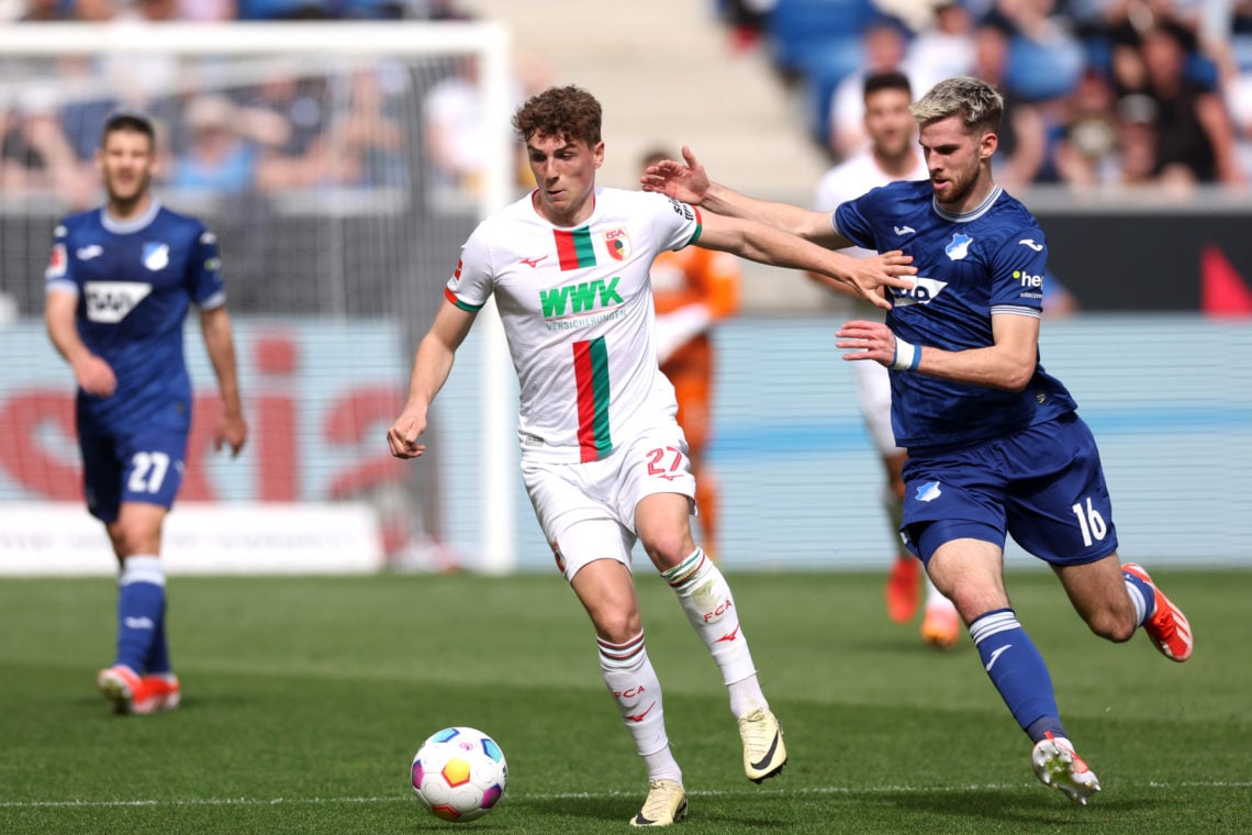 Arne Engels of FC Augsburg is challenged by Anton Stach of TSG 1899 Hoffenheim during the Bundesliga match between TSG Hoffenheim and FC Augsburg a...