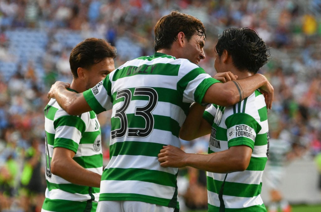 Celtic's German forward #10 Nicolas-Gerrit Kühn celebrates scoring his team's first goal with Celtic's English midfielder #33 Matt O'Riley during t...