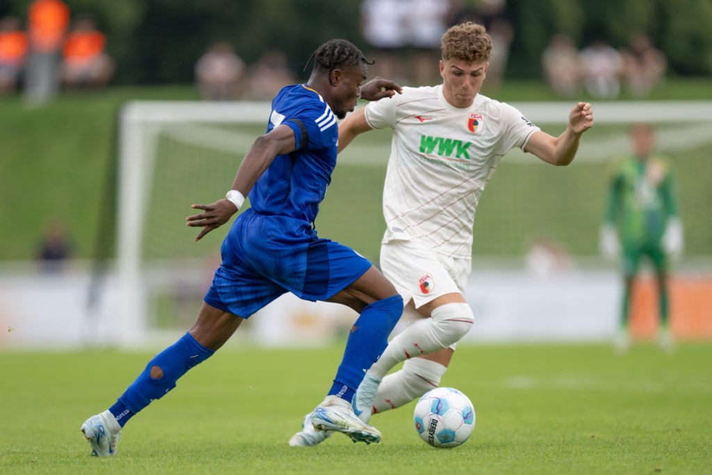 Abdul Fatawu of Leicester City FC challenges Arne Engels of FC Augsburg during the pre-season friendly match between FC Augsburg and Leicester City...