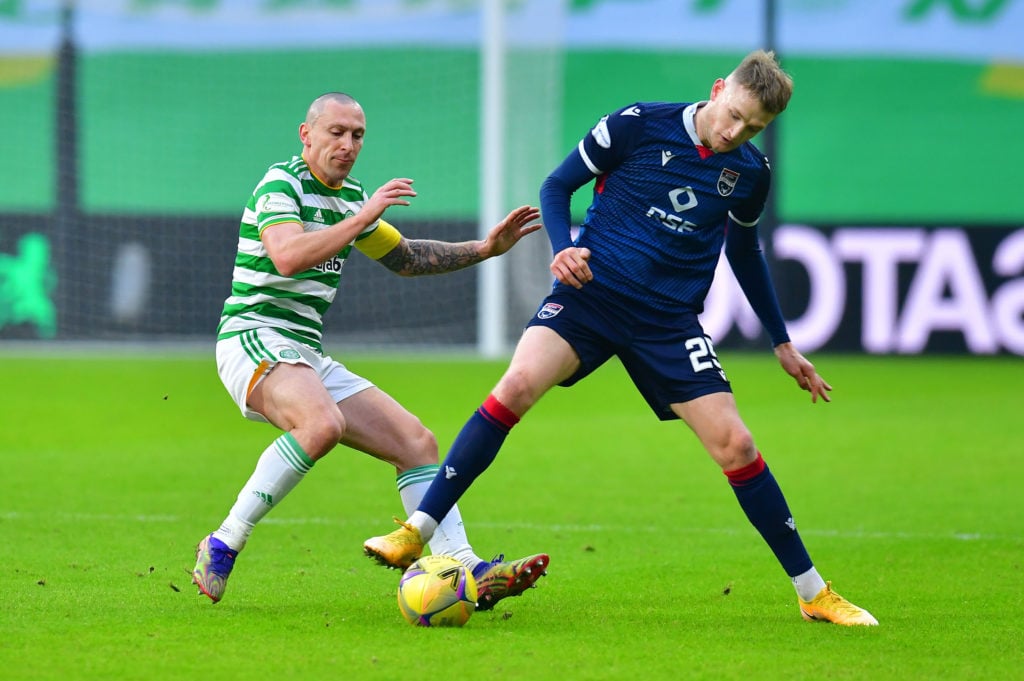 Coll Donaldson of Ross County battles for possession with Scott Brown of Celtic during the Betfred Cup match between Celtic and Ross County at Celt...