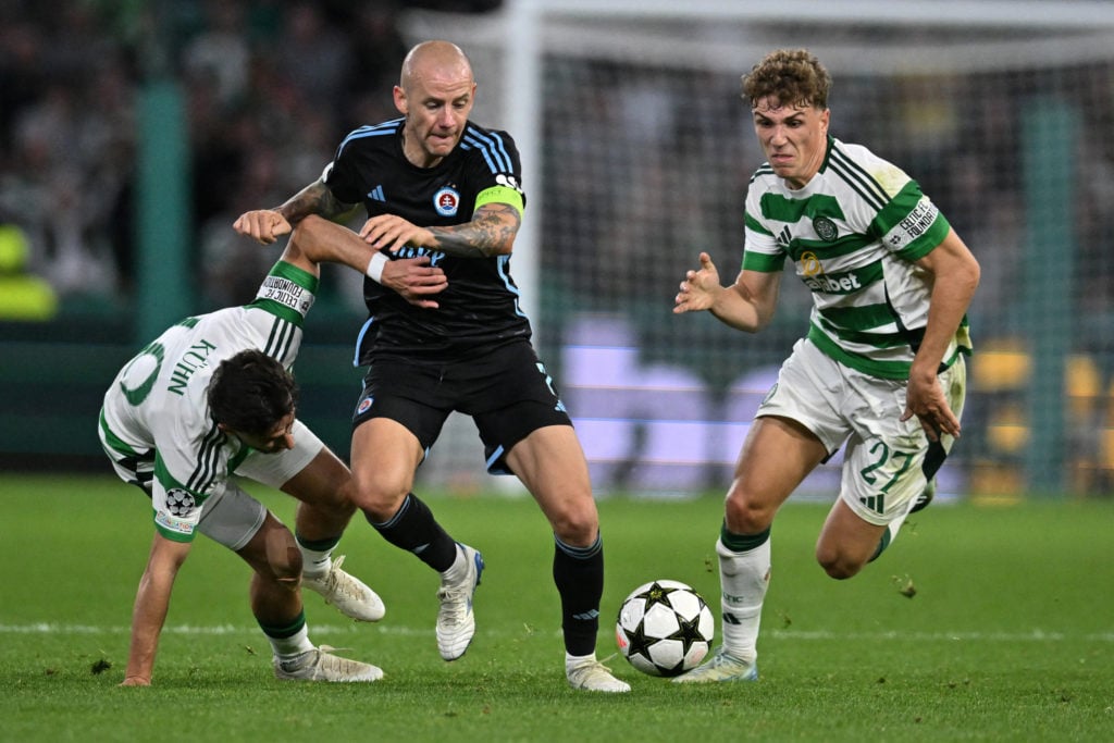 Celtic's German midfielder #10 Nicolas Kuhn (L) and Celtic's Belgian midfielder #27 Arne Engels (R) compete for the ball with Slovan Bratislava's S...