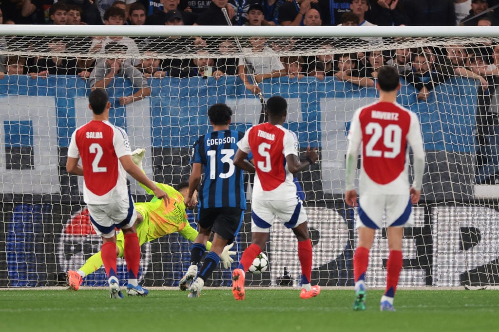 David Raya of Arsenal FC palms away a Matteo Retegui of Atalanta header from a rebounded penalty to keep his goal in tact during the UEFA Champions...