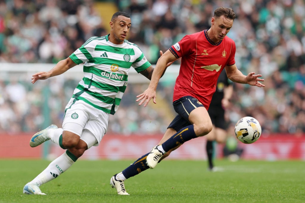 Liam Henderson of Falkirk FC runs with the ball under pressure from Adam Idah of Celtic during the Premier Sports Cup Quarter Final between Celtic ...