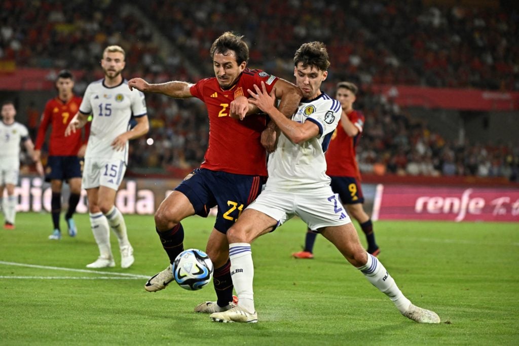 Spain's midfielder #21 Mikel Oyarzabal vies Scotland's defender #02 Aaron Hickey during the EURO 2024 first round group A qualifying football match...