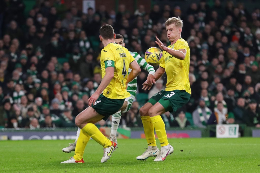 Josh Doig of Hibernian  concedes a penalty as he handles the ball in the penalty area during the Cinch Scottish Premiership match between Celtic FC...