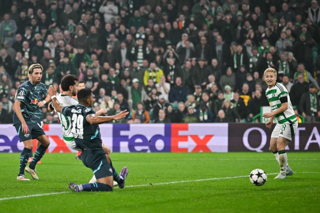 Celtic's German midfielder #10 Nicolas Kuhn (2nd L) shoots the ball and scores his team second goal during the UEFA Champions League football match...