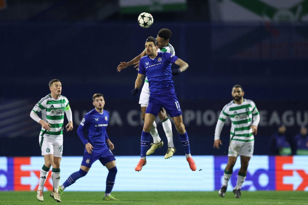 Dinamo Zagreb's Croatian forward #77 Dario Spikic (C-L) fights for the ball with Celtic's US defender #06 Auston Trusty (C-R) during the UEFA Champ...