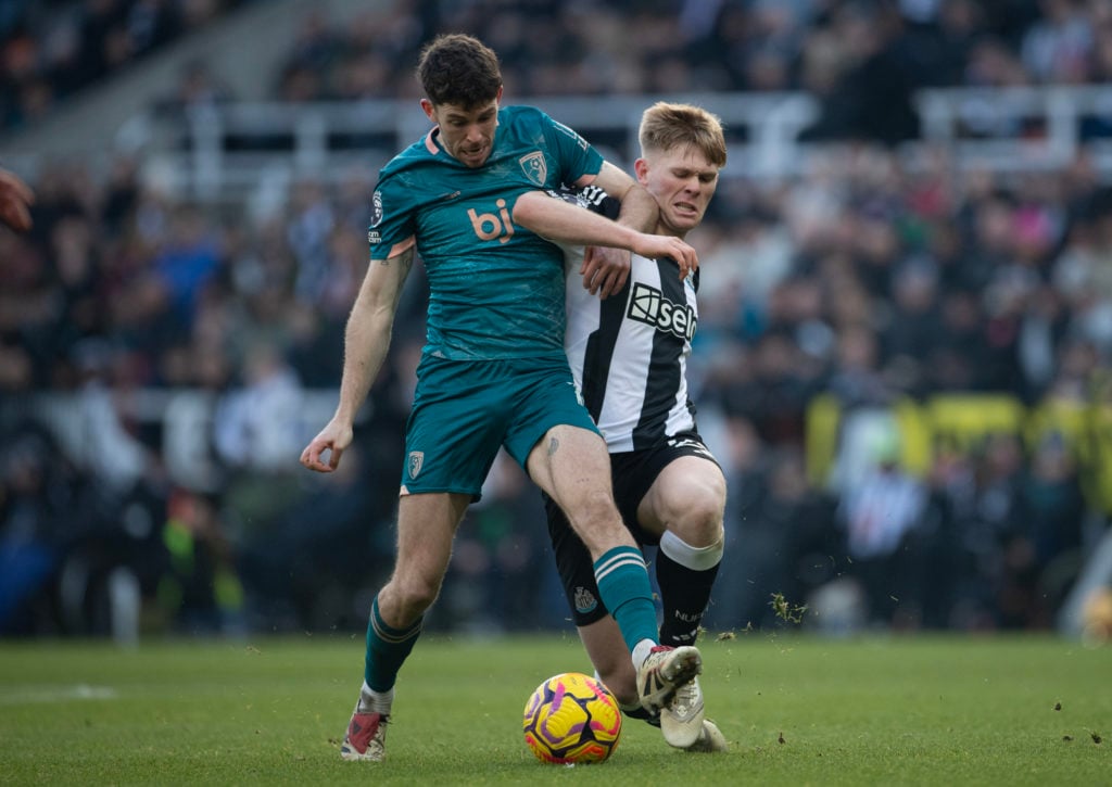 Lewis Hall of Newcastle United is challenged by Ryan Christie of AFC Bournemouth during the Premier League match between Newcastle United FC and AF...