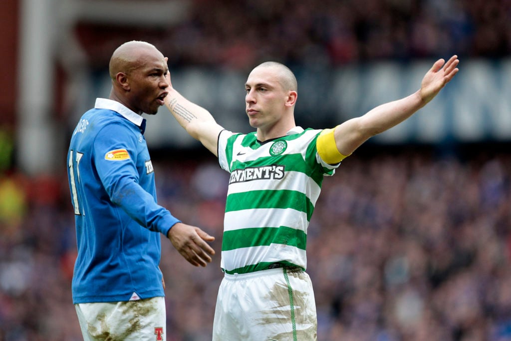 Scott Brown celebrates in front of El Hadji Diouf after scoring for Celtic against Rangers.