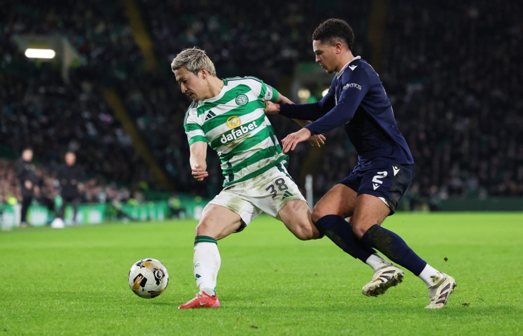 Daizen Maeda of Celtic controls the ball whilst under pressure from Ethan Ingram of Dundee FC during the William Hill Premiership match between Cel...