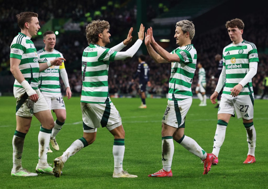 Daizen Maeda of Celtic celebrates scoring his team's third goal with teammate Jota during the William Hill Premiership match between Celtic FC and ...