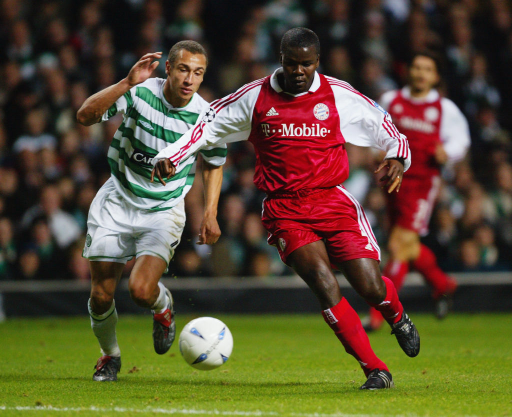Henrik Larsson of Celtic and Samuel Kuffour of Bayern Munich tussle for the ball
