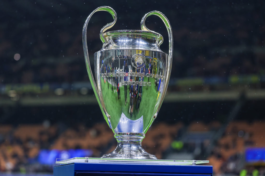 The UEFA Champions League trophy is displayed on a plinth at the San Siro