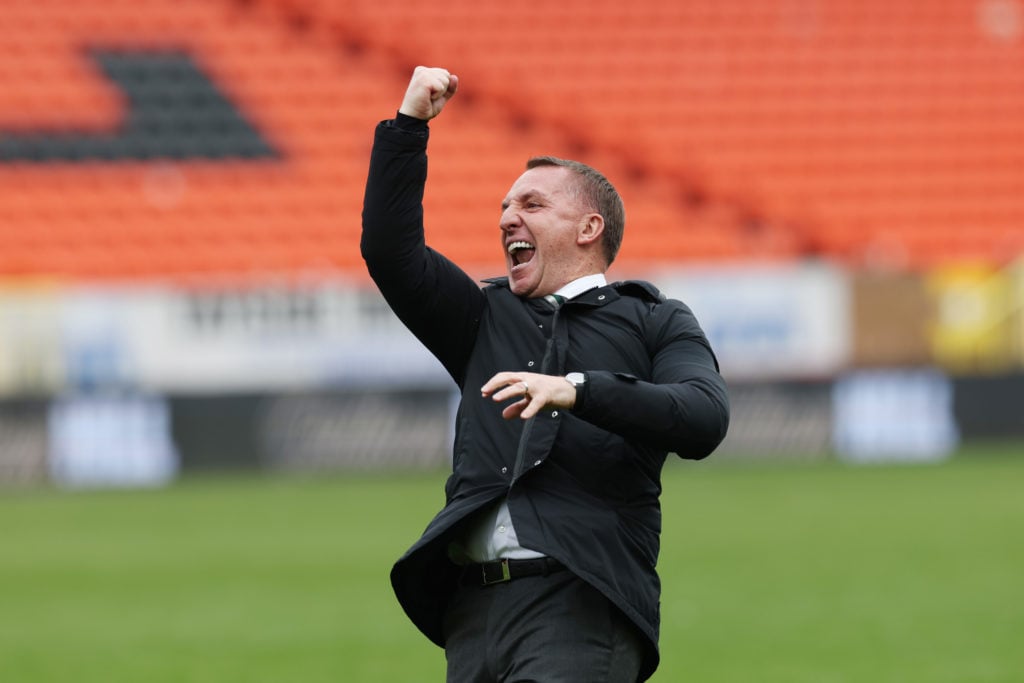 Brendan Rodgers celebrates with Celtic fans after winning the Scottish Premiership