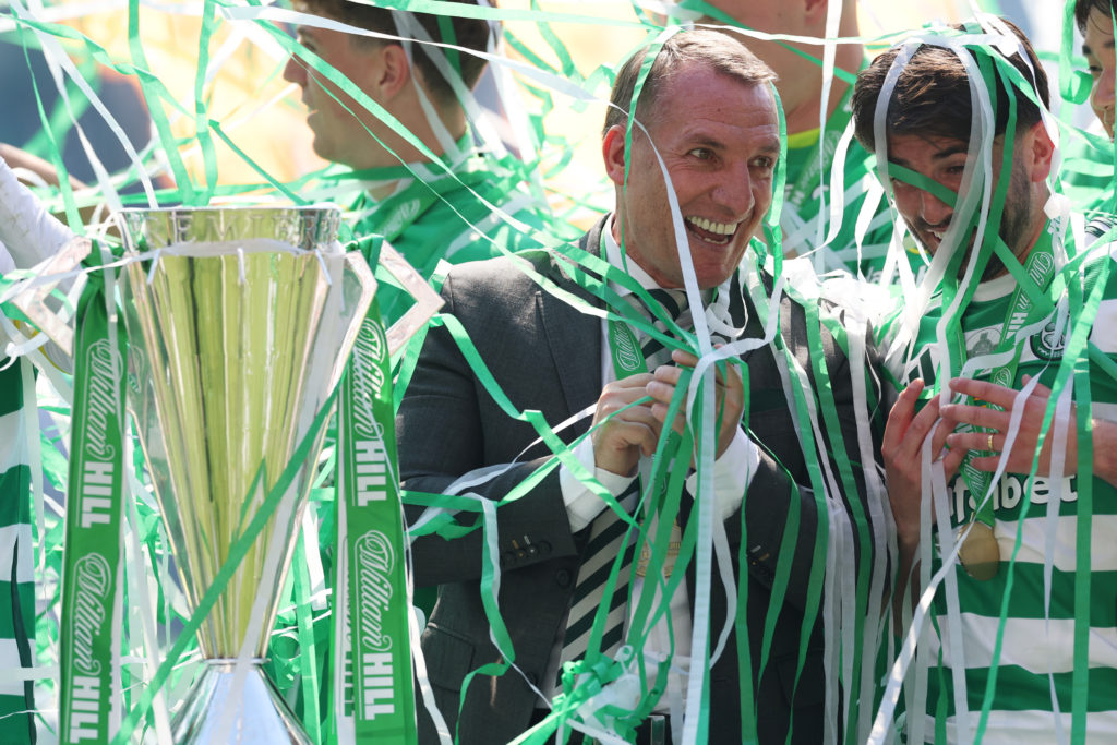 Brendan Rodgers celebrates with Celtic's players after winning Scottish Premiership
